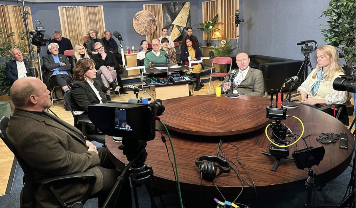 A roundtable discussion with guests and an audience in the United Action TV studio